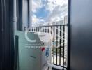 Compact balcony with city view and outdoor air conditioning unit