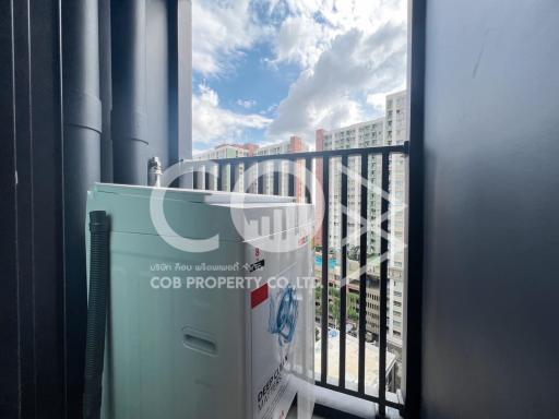 Compact balcony with city view and outdoor air conditioning unit