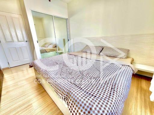 Cozy bedroom with ample lighting and mirrored wardrobe