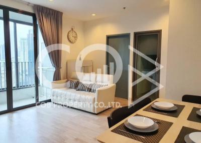 Spacious and well-lit living room with balcony access