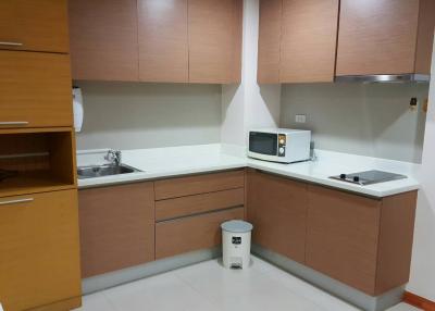 Modern kitchen interior with wooden cabinets and stainless steel appliances