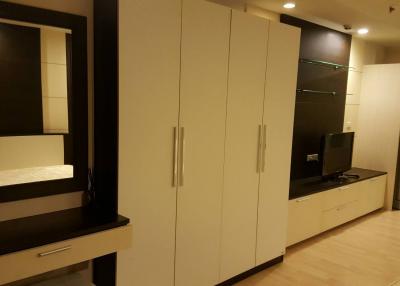 Modern living room interior with large storage cabinets and mounted flat screen television