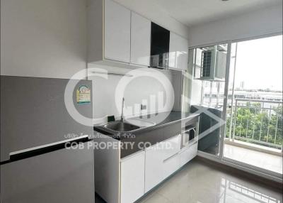 Modern kitchen with white cabinets and stainless steel appliances