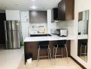 Modern kitchen with stainless steel appliances and a breakfast bar