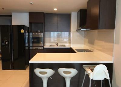 Modern kitchen with stainless steel appliances and breakfast bar