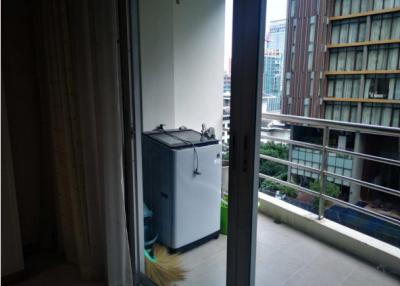 Compact balcony with laundry appliance and city view