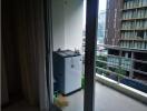 Compact balcony with laundry appliance and city view