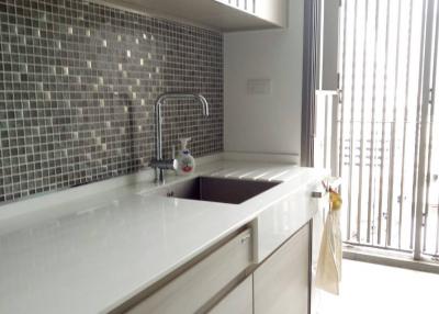 Modern kitchen with natural light and mosaic backsplash