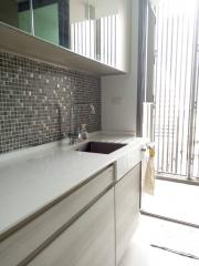 Modern kitchen with natural light and mosaic backsplash