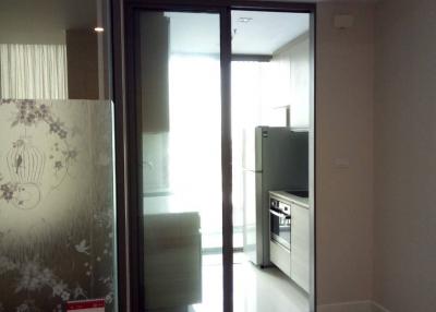 Modern kitchen interior with glass door and sleek appliances