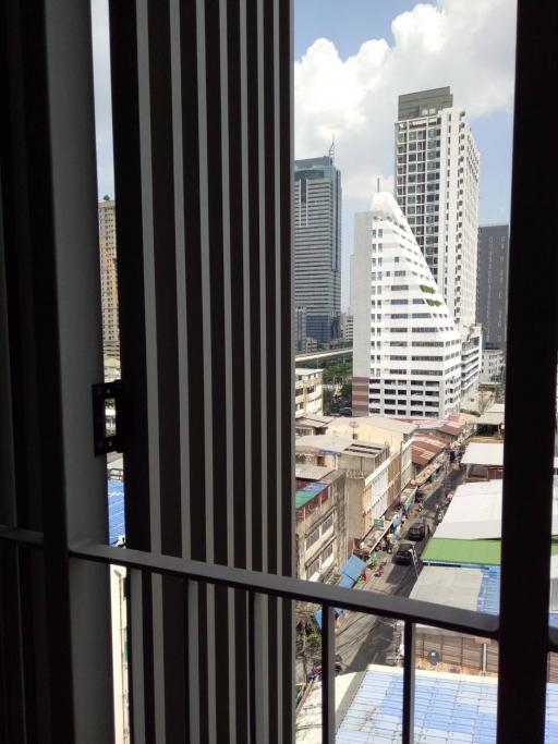 Urban view from a high-rise building window, showcasing the cityscape and skyline