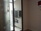 Small modern kitchen viewed through glass door