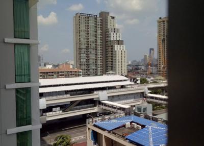 City view showing various buildings and infrastructure from a high-rise window