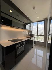 Modern kitchen with stainless steel appliances and city view