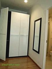 Compact bedroom with a large wardrobe and hardwood flooring