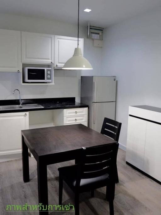 Modern kitchen with stainless steel appliances and a wooden dining table