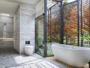Modern bathroom with natural light and freestanding tub