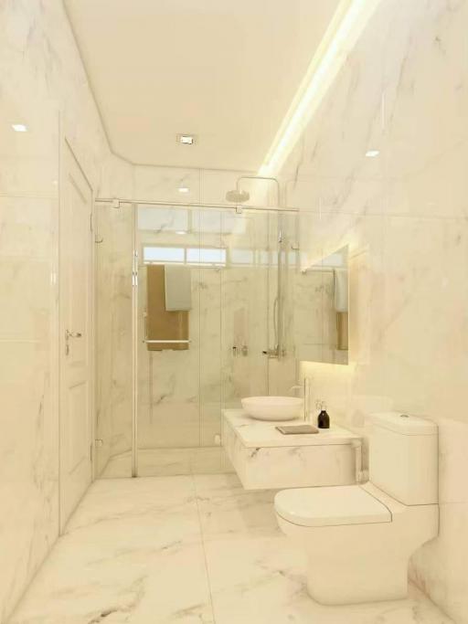 Modern Bathroom with Marble Finish and Glass Shower Enclosure