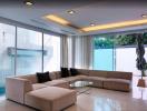 Spacious and modern living room with large sofa and ample natural light