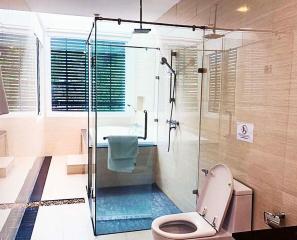 Modern bathroom with glass shower enclosure and natural light