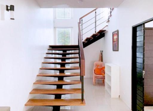 Elegant wooden staircase with white walls in a modern home