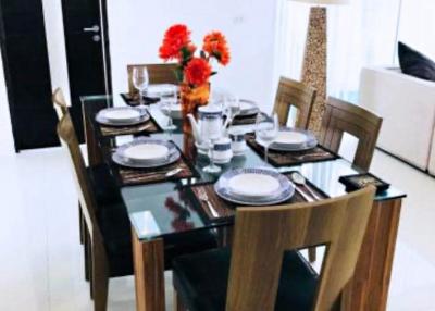 Elegantly set dining table in a modern dining room with bright interior