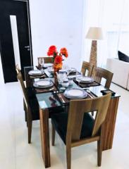 Elegantly set dining table in a modern dining room with bright interior