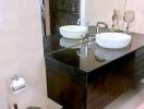 Modern bathroom with double vanity sinks, large mirror, and ample lighting
