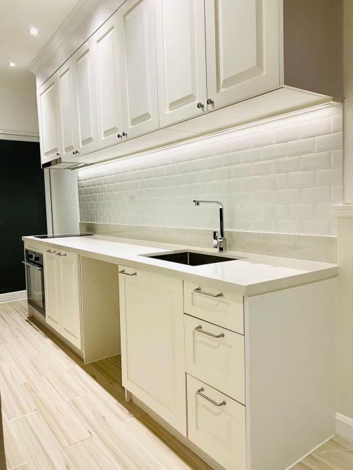 Modern kitchen with white cabinetry and stainless steel appliances