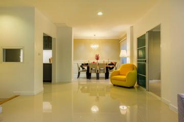 Spacious and well-lit living room with adjoining dining space featuring modern furniture and elegant decor