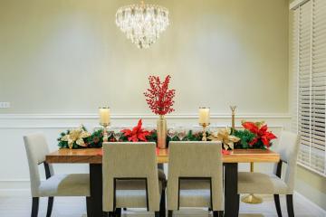 Elegant dining room with a festive centerpiece and modern chandelier