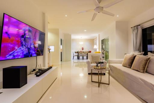 Spacious living room with modern furniture and large flat-screen TV