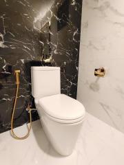 Modern bathroom with stylish marble walls and gold fixtures