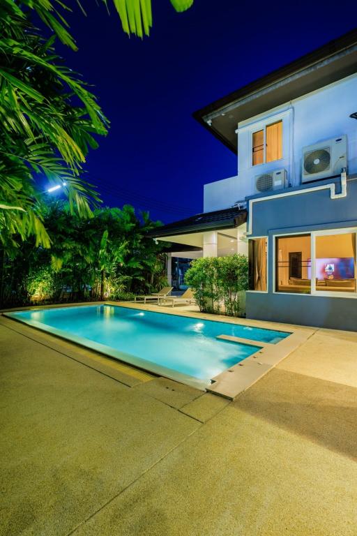 Elegant house exterior with swimming pool at twilight