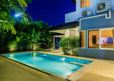 Elegant house exterior with swimming pool at twilight