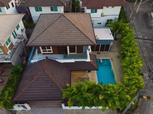 Aerial view of a residential house with pool
