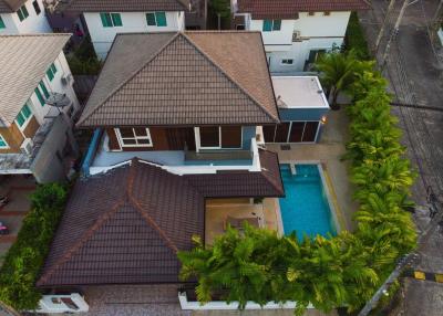 Aerial view of a residential house with pool