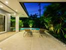 Spacious patio area with swimming pool and lounge chairs at dusk