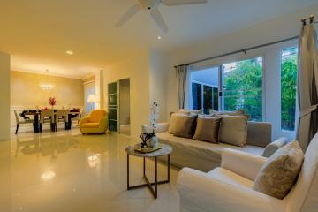 Spacious and well-lit living room with modern furniture and large windows