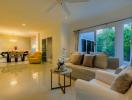 Spacious and well-lit living room with modern furniture and large windows