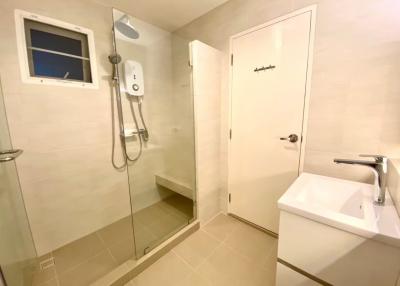 Modern bathroom with walk-in shower and beige tiles