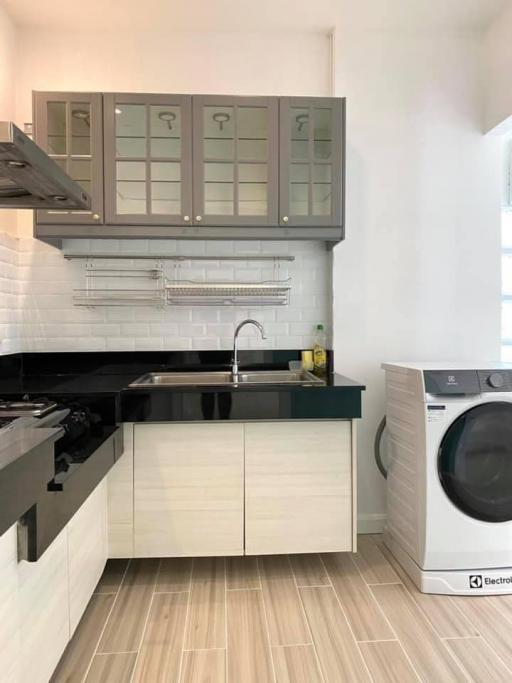 Modern kitchen with stainless steel appliances and white cabinetry