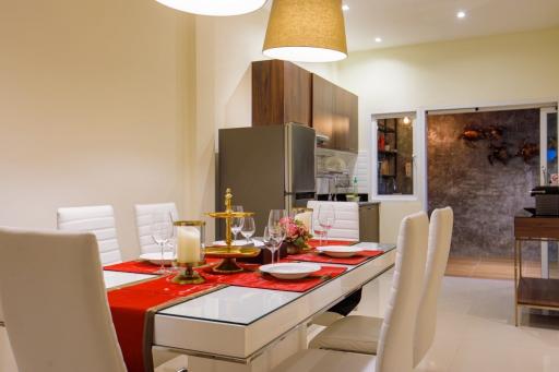 Modern dining room with elegant table setting and open-plan layout