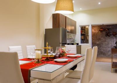 Modern dining room with elegant table setting and open-plan layout