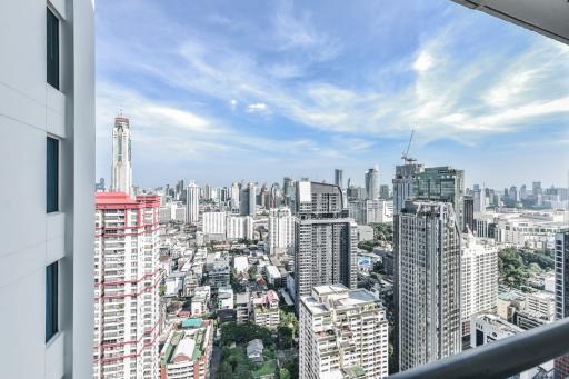 Panoramic city view from a high-rise apartment balcony