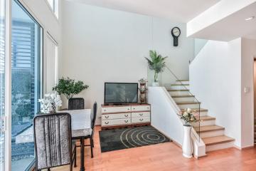 Modern living room interior with staircase and television