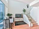 Modern living room interior with staircase and television