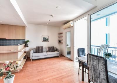 Spacious and bright living room with adjacent kitchen and balcony access
