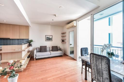 Spacious and bright living room with adjacent kitchen and balcony access