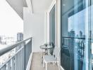 Modern balcony with city view featuring seating area and transparent railing